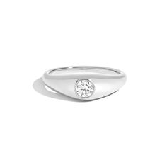 a white gold ring with a single diamond