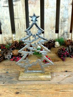 a small metal christmas tree sitting on top of a wooden table