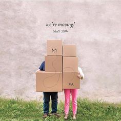 two people are holding cardboard boxes with the words we're moving