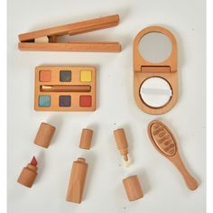 an assortment of wooden toys including a brush, mirror and other items