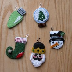 christmas ornaments are arranged on a wooden surface