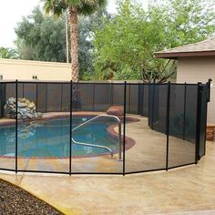 a pool with a fence around it and a swimming pool in the backround