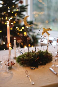 the table is set with silverware and candles