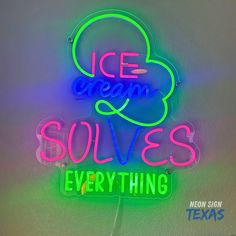 a neon sign that says ice cream solves everything