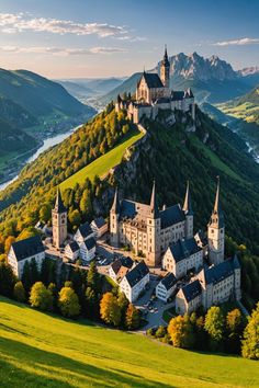 an old castle on top of a hill with trees in the foreground and mountains in the background