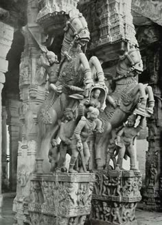 an old black and white photo of statues on the side of a building in india