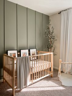 a baby's crib in the corner of a room with pictures on it