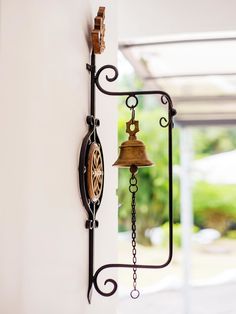 a bell hanging from the side of a wall