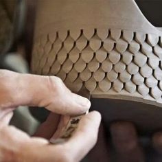 a person is working on a piece of pottery with their fingers and thumbnails