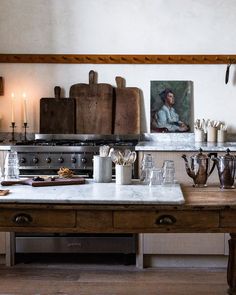 an old fashioned kitchen with pots and pans on the counter