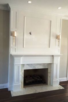 an empty fireplace in a room with white walls