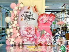 a birthday party with balloons and decorations in the shape of flowers, butterflies and hearts