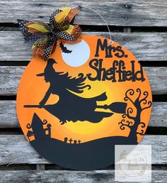 a wooden sign that says mrs sheffield with a witch riding a broom on top of it