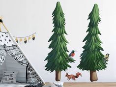 the wall decals are decorated with pine trees and small birds in front of them