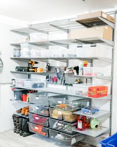 the shelves are filled with various items and storage bins, including boxes, tools and other things