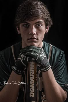 a young man wearing boxing gloves and holding his hands to his face while posing for the camera