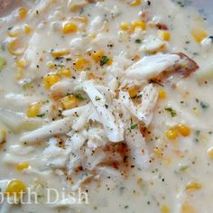 a white bowl filled with corn and chicken chowdery on top of a table