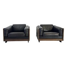 two black leather chairs sitting next to each other