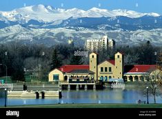 the mountains are covered in snow as seen from across the lake, with buildings on either side - stock image