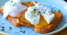 two pieces of toast with sour cream and butter on them sitting on a blue plate