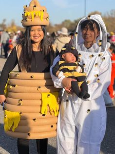 two women and a baby dressed up in costumes for the costume parade, one holding a child