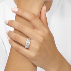 a woman's hand with a diamond ring on it