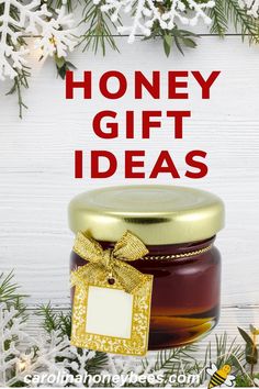 a jar of honey sitting on top of a wooden table next to snowflakes