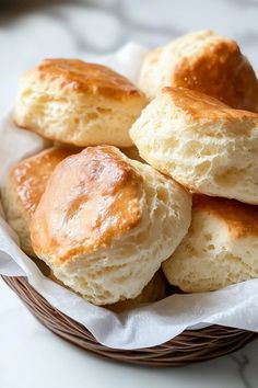 a basket full of biscuits sitting on top of a table