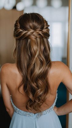 the back of a woman's head wearing a blue dress