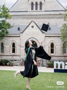 a woman in graduation gown throwing her cap into the air