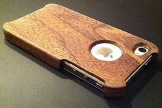 an iphone case made out of wood with two holes in the back and one hole at the front