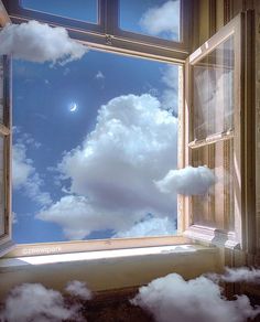 an open window with the sky and clouds reflected in it