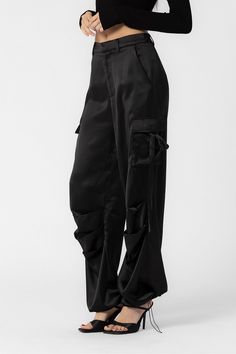 These black Elly cargo pants feature cargo pockets on the side and an adjustable drawstring on the ankle perfect for customizing your fit as needed. Loose fitting 100% polyester SALE ITEMS ARE FINAL SALE Return Policy SALE ITEMS ARE FINAL SALE. Feel free to email us at info@shopluxxeapparel.com or DM us with any questions regarding fit, styling, or our return policy in general. To read more into our return policy please click here. Black Satin Cargo Pants, Satin Cargo Pants, Cargo Pants Outfit Women, Cargo Pants Outfit, Black Cargo Pants, Huge Sale, Black Cargo, Pants Outfit, Black Media