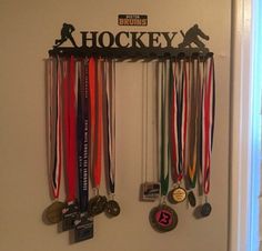 there are many medals hanging on the wall in this room, including one for hockey