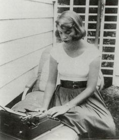 a woman sitting on the porch with an old typewriter