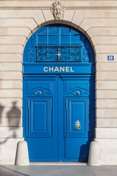 a blue door with the word chanel on it is in front of a building