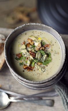 a bowl of soup with bread on the side