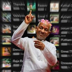 an old man with a flower in his hair pointing to something on the wall behind him