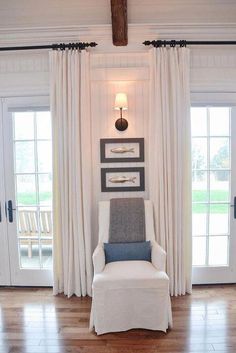 a white chair sitting in front of two doors