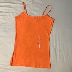 This New Planet Gold Tank Top Features No Lining, Stretch Fabric, Sleeveless And Pullover Style. Casual Camisole With Built-in Bra And Wide Straps, Casual Summer Vest With Built-in Bra, Basic Tank Top With Spaghetti Straps And Built-in Bra, Stretch Summer Tank Top, Seamless Orange Sleeveless Tank Top, Orange Seamless Sleeveless Tank Top, Seamless Sleeveless Orange Tank Top, Solid Fitted Summer Tank Top, Stretch Cami Tank Top For Summer