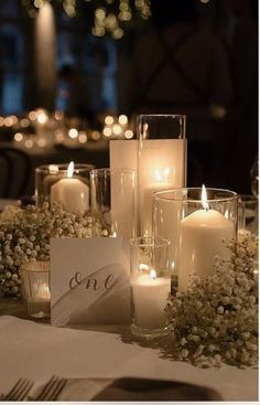 a table with candles and place cards on it