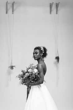 a black and white photo of a woman in a wedding dress