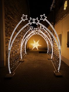 an archway is decorated with lights and stars