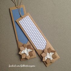 two brown paper tags with blue and white polka dots on them, one has an origami flower