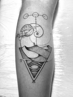 a black and white photo of a tattoo on the leg