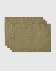 four linen placemats on a white background