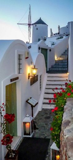 an image of a house with stairs and flowers