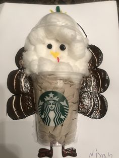 a starbucks cup with an owl face on it