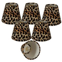 six leopard print lampshades and one lamp shade with an animal print design on them