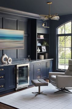 a living room filled with furniture and a painting on the wall above it's fireplace